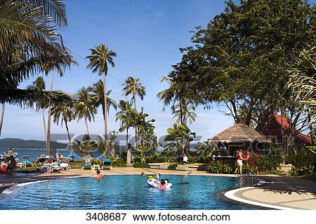 Swimming pool at Pantai Tengah beach, Langkawi Island, Malaysia, elevated view View Large Photo Image Stock Photo - Swimming pool at Pantai Tengah beach, Langkawi Island, Malaysia, elevated view . Fotosearch