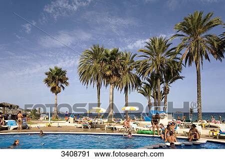 Stock Image - Swimming pool at the beach of Platja den Bossa, Ibiza, Spain . Fotosearch