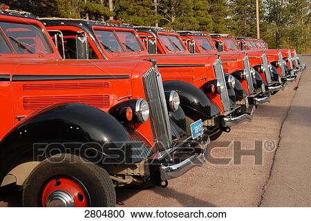 Stock Image - Taxi parked in row at taxi stand, Glacier National Park, Montana, USA . Fotosearch
