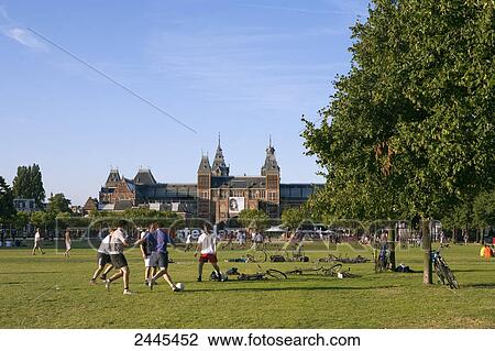 Teenage boys playing soccer in park, Rijksmuseum, Amsterdam, Netherlands View Large Photo Image Stock Image - Teenage boys playing soccer in park, Rijksmuseum, Amsterdam, Netherlands . Fotosearch