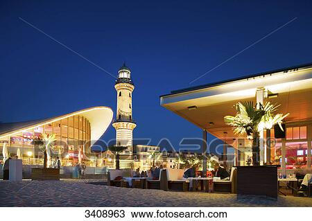 Teepott, lighthouse and beach bar in Warnemuende, Rostock, Germany View Large Photo Image Stock Image - Teepott, lighthouse and beach bar in Warnemuende, Rostock, Germany . Fotosearch
