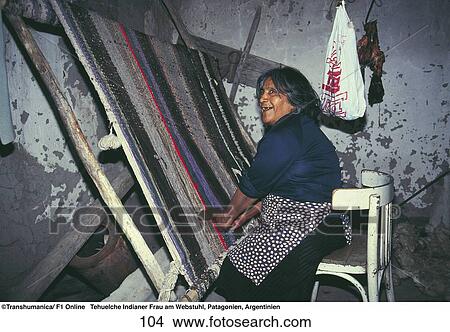 Picture - Tehuelche Indian woman weaving with a loom, Patagonia, Argentina . Fotosearch