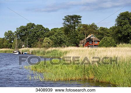 Thatched-roof house at a waterfront, Darß, Germany View Large Photo Image Stock Photo - Thatched-roof house at a waterfront, Darß, Germany . Fotosearch