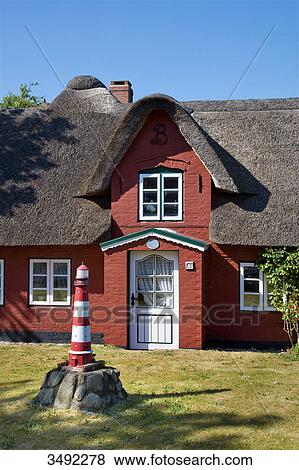 Stock Photo - Thatched-roof house in Norddorf, Amrum, Schleswig-Holstein, Germany . Fotosearch