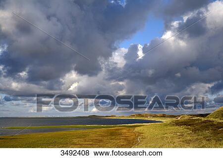 Stock Photo - Thunderclouds above a beach, Ellenbogen, Sylt, Germany . Fotosearch