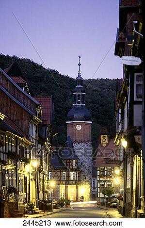Stock Image - Timber-framed houses lit up at dusk in town, Stolberg, Saxony-Anhalt, Germany . Fotosearch