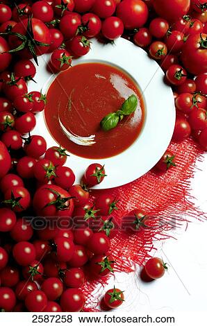 Stock Photo - Tomatoes and tomato soup, elevated view . Fotosearch