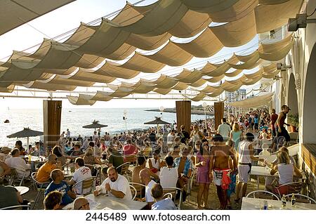 Stock Photo - Tourists at beachbar, Sant Antoni, Ibiza, Balearic Islands, Spain . Fotosearch