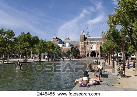 Tourists at canal side in front of museum, Rijksmuseum, Amsterdam, Netherlands View Large Photo Image Stock Photograph - Tourists at canal side in front of museum, Rijksmuseum, Amsterdam, Netherlands . Fotosearch
