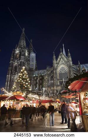 Stock Image - Tourists at market in front of cathedral . Fotosearch