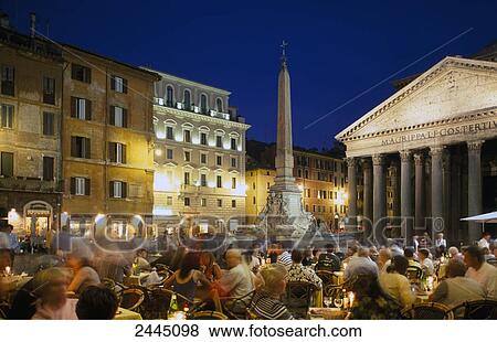 Stock Photo - Tourists at sidewalk cafe during dusk . Fotosearch