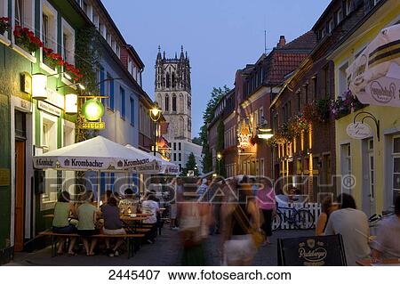 Tourists at sidewalk cafe in street during dusk View Large Photo Image Stock Photo - Tourists at sidewalk cafe in street during dusk . Fotosearch