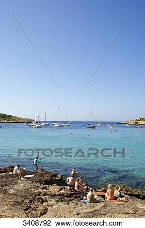 Tourists at the coast of Portinatx, Ibiza, Spain, elevated view View Large Photo Image Stock Image - Tourists at the coast of Portinatx, Ibiza, Spain, elevated view . Fotosearch