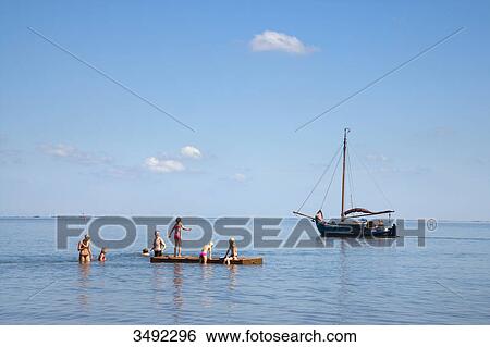 Stock Photograph - Tourists bathing in the North Sea, Wyk, Föhr, Schleswig-Holstein, Germany . Fotosearch
