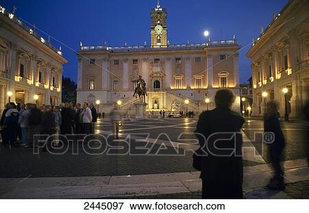 Stock Photo - Tourists in front of lit up building, Piazza Del Campidoglio, Rome, Italy . Fotosearch
