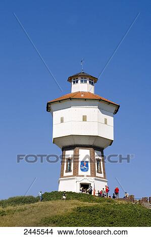 Picture - Tourists near lighthouse, Langeoog, Lower Saxony, Germany . Fotosearch