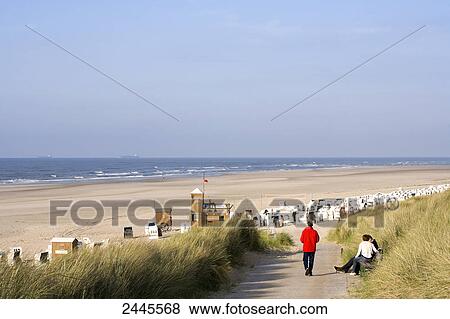 Tourists on beach, Spiekeroog, Lower Saxony, Germany View Large Photo Image Stock Photo - Tourists on beach, Spiekeroog, Lower Saxony, Germany . Fotosearch