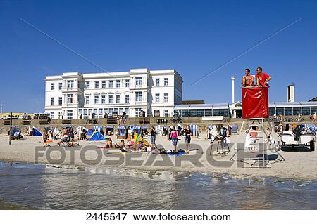 Stock Photo - Tourists on beach, Western Beach, Lower Saxony, Germany . Fotosearch