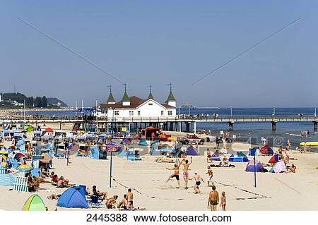 Stock Photo - Tourists on beach with pier in background, Ahlbeck, Usedom, Mecklenburg-West Pomerania, Germany . Fotosearch