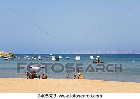 Tourists on the beach, Gnejna Bay, Malta View Large Photo Image Stock Image - Tourists on the beach, Gnejna Bay, Malta . Fotosearch