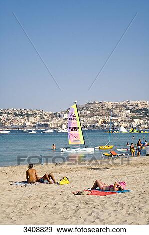 Tourists on the beach, Mellieha Bay, Malta View Large Photo Image Stock Photo - Tourists on the beach, Mellieha Bay, Malta . Fotosearch