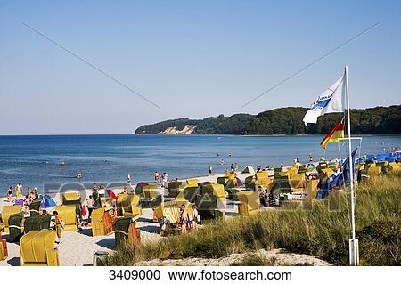 Stock Image - Tourists on the beach of Binz, flags in the foreground, Ruegen, Germany . Fotosearch