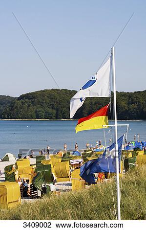 Tourists on the beach of Binz, flags in the foreground, Ruegen, Germany View Large Photo Image Stock Image - Tourists on the beach of Binz, flags in the foreground, Ruegen, Germany . Fotosearch