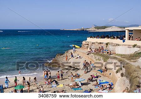 Tourists on the beach of Cala Comte, Ibiza, Spain, elevated view View Large Photo Image Stock Photo - Tourists on the beach of Cala Comte, Ibiza, Spain, elevated view . Fotosearch