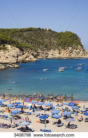 Stock Photo - Tourists on the beach of Puerto de San Miguel, Ibiza, Spain, elevated view . Fotosearch