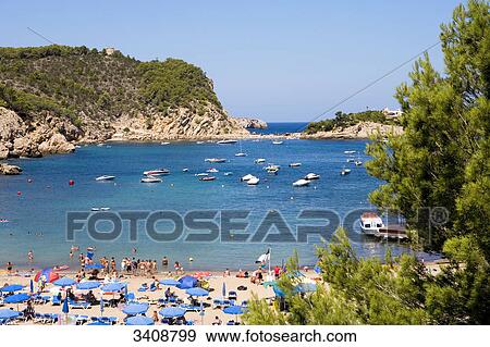 Tourists on the beach of Puerto de San Miguel, Ibiza, Spain, elevated view View Large Photo Image Stock Photo - Tourists on the beach of Puerto de San Miguel, Ibiza, Spain, elevated view . Fotosearch