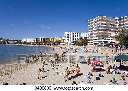 Stock Photograph - Tourists on the beach of Santa Eularia des Riu, Ibiza, Spain, elevated view . Fotosearch