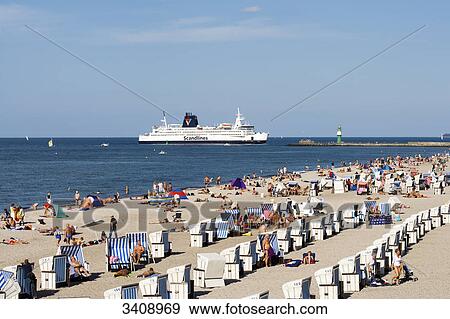 Stock Photo - Tourists on the beach of Warnemuende, ferry in the background, Rostock, Germany, elevated view . Fotosearch