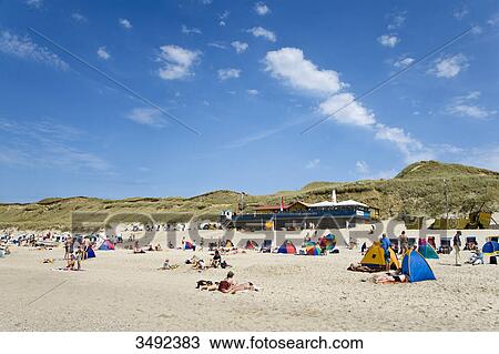 Stock Image - Tourists on the beach, Wenningstedt-Braderup, Sylt, Schleswig-Holstein, Germany . Fotosearch