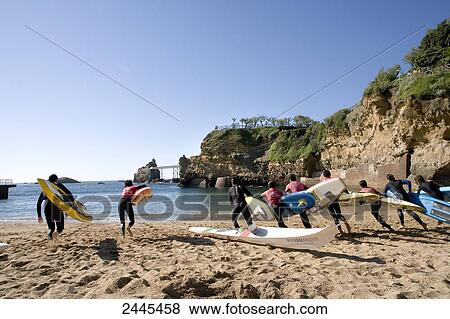 Tourists running with surfboards on beach, Port Vieux, Biarritz, Pyrenees-Atlantiques, Aquitaine, France View Large Photo Image Stock Photo - Tourists running with surfboards on beach, Port Vieux, Biarritz, Pyrenees-Atlantiques, Aquitaine, France . Fotosearch