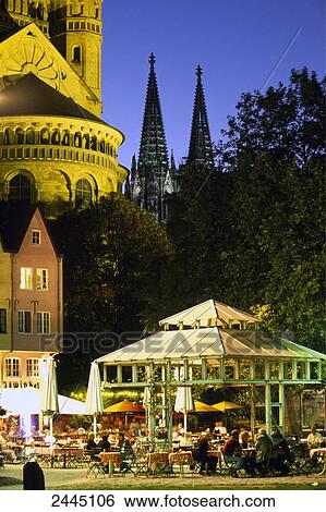 Stock Photograph - Tourists sitting at outdoor cafe, Cologne, Rhineland, North Rhine-Westphalia, Germany . Fotosearch