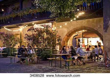 Stock Photo - Tourists sitting in outdoot restaurant, Colmar, France . Fotosearch