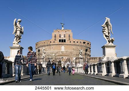 Tourists walking on bridge in front of cathedral, Castle Sant'Angelo, Ponte Sant'Angelo, Rome, Italy View Large Photo Image Stock Image - Tourists walking on bridge in front of cathedral, Castle Sant'Angelo, Ponte Sant'Angelo, Rome, Italy . Fotosearch