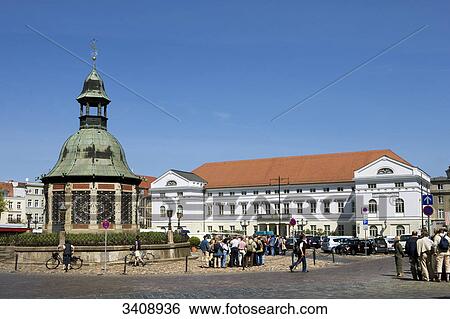 Town hall and a memorial (Wasserkunst) at the marketplace of Wismar, Germany View Large Photo Image Stock Photograph - Town hall and a memorial (Wasserkunst) at the marketplace of Wismar, Germany . Fotosearch