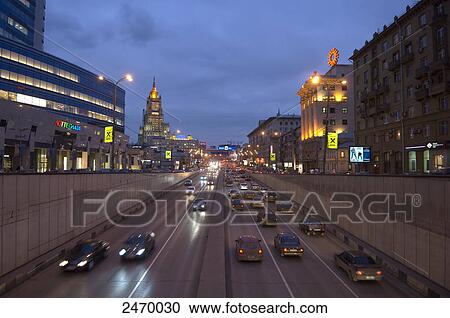 Stock Image - Traffic on road at dusk, Arbatskaya Station, Moscow, Russia . Fotosearch