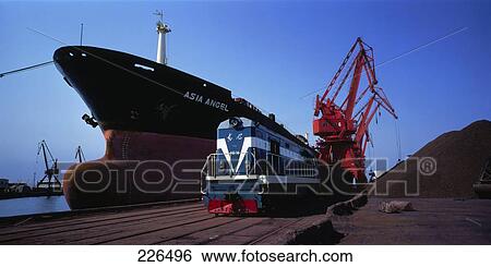 Train engine near ship docked at commercial dock, China View Large Photo Image Stock Photograph - Train engine near ship docked at commercial dock, China . Fotosearch