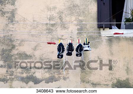 Trainers drying on a clothesline, Chioggia, Italy, low angle view View Large Photo Image Stock Image - Trainers drying on a clothesline, Chioggia, Italy, low angle view . Fotosearch