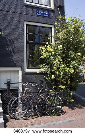 Two bicycles beside a house, Amsterdam, Netherlands View Large Photo Image Stock Photo - Two bicycles beside a house, Amsterdam, Netherlands . Fotosearch