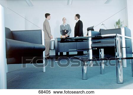 Two businessmen and businesswoman standing in conference room View Large Photo Image Stock Photography - Two businessmen and businesswoman standing in conference room . Fotosearch