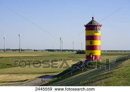 Two people standing in front of lighthouse, Pilsum, Lower Saxony, Germany View Large Photo Image Stock Photo - Two people standing in front of lighthouse, Pilsum, Lower Saxony, Germany . Fotosearch