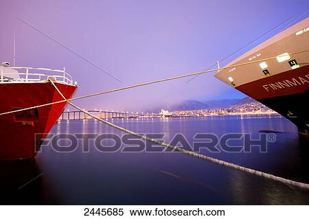 Stock Photography - Two ships moored with city and bridge in background, Norway . Fotosearch
