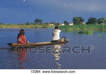 Two women on canoe in river, Ucayali River, Pucallpa, Peru View Large Photo Image Picture - Two women on canoe in river, Ucayali River, Pucallpa, Peru . Fotosearch