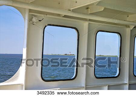 Stock Photography - View from a ferry on a lighthouse in Pellworm, Schleswig-Holstein, Germany . Fotosearch