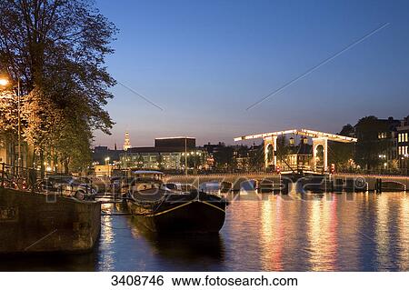 View of Amstel River and Magere Brug in the evening, Amsterdam, Netherlands View Large Photo Image Stock Photograph - View of Amstel River and Magere Brug in the evening, Amsterdam, Netherlands . Fotosearch