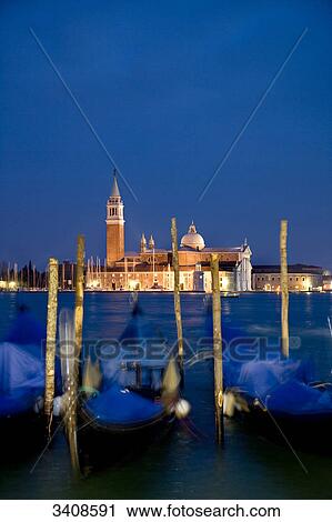 Stock Image - View of San Giorgio Maggiore, moored gondolas in the foreground, Venice, Italy . Fotosearch