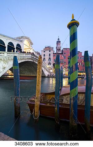 View of the Rialto Bridge, boat and wooden pillars in the foreground, Venice, Italy View Large Photo Image Stock Image - View of the Rialto Bridge, boat and wooden pillars in the foreground, Venice, Italy . Fotosearch
